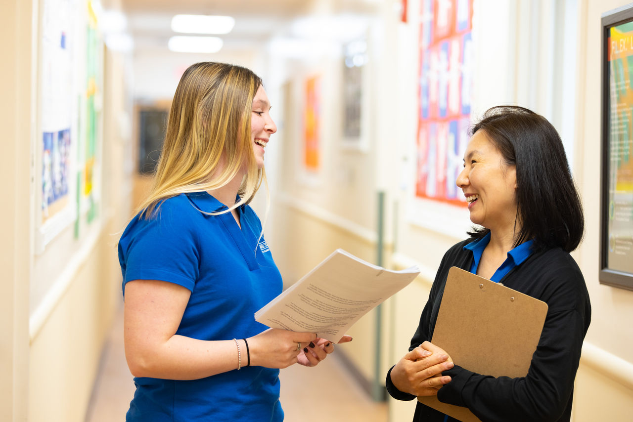 Franchisee speaking with staff member